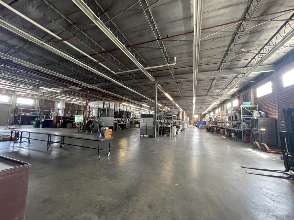 Large industrial plant floor with overhead lighting